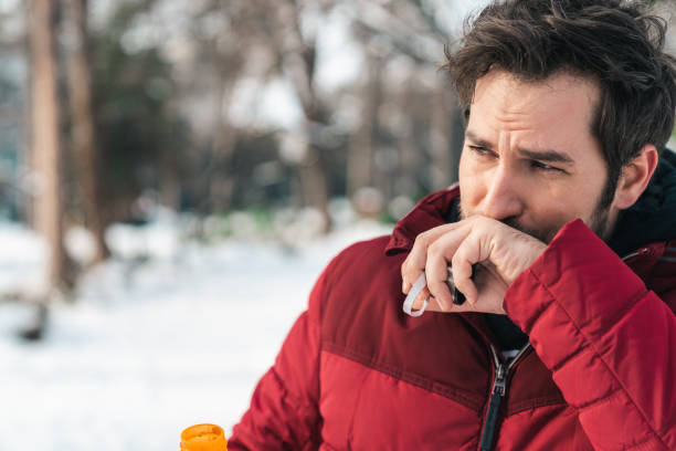 istock Man wiping mouth after drinking water in winter 1877958657