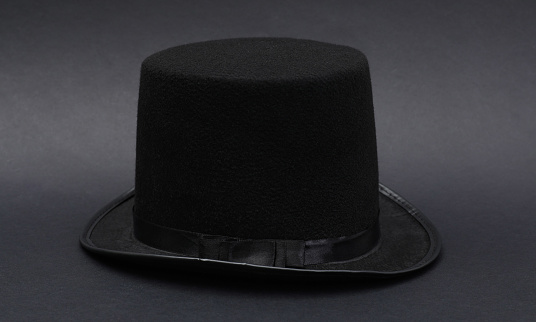 One magician top hat on dark grey background