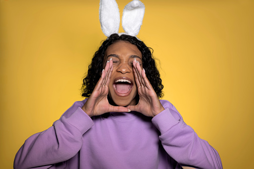 Easter sale or offers. Funny girl in easter bunny ears shouting. Advertisment,promotion etc. High quality photo