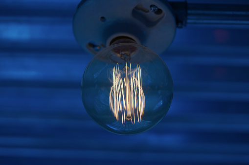 Close-up of a light fixture with blue background