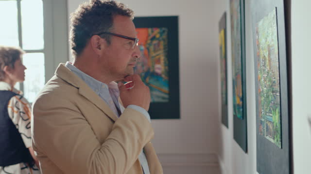 Thoughtful Man Scrutinizing Painting in Art Gallery