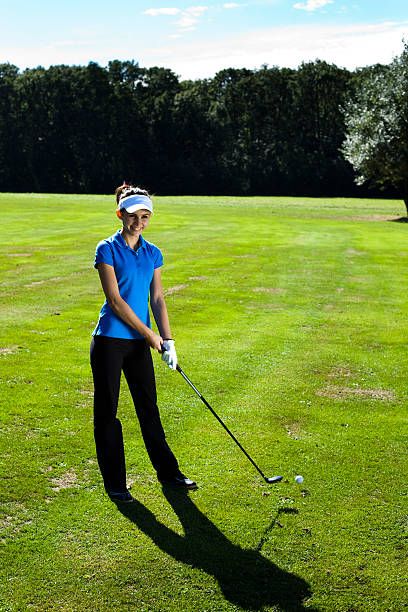 istock Woman playing golf on field 187804702