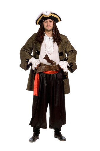 Young man in a pirate costume with pistol. Isolated on white