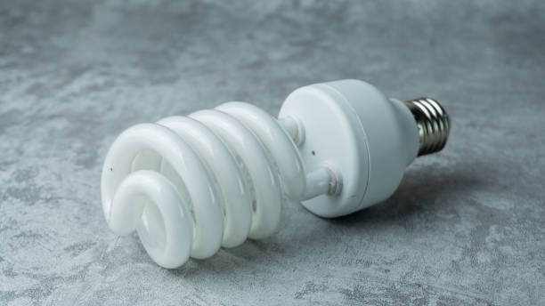 istock Spiral shaped bulbs on a gray background with concrete texture 1878088015