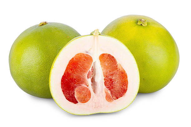 istock Two whole and one halved Pomelo Fruits 187809259