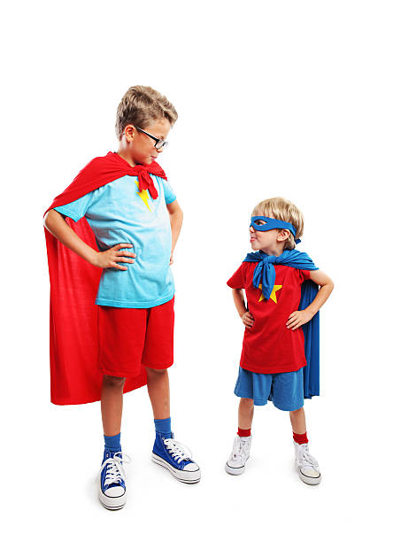 Super friends Portrait of a team of two young superheroes teenager couple child blond hair stock pictures, royalty-free photos & images