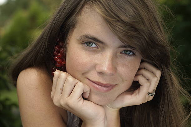 young woman sitting on a tiled floor. 