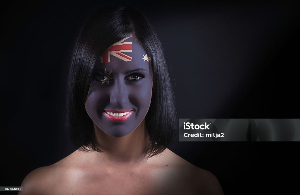 Australian flag face Young woman with the flag painted on her face. Audience Stock Photo