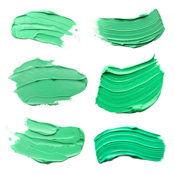 istock Light green oil paint strokes isolated on white, top view 1878139823