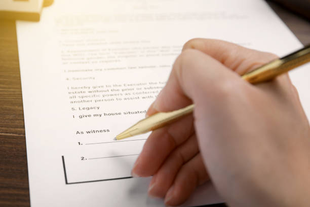 istock Woman signing Last Will and Testament at table, closeup 1878142383