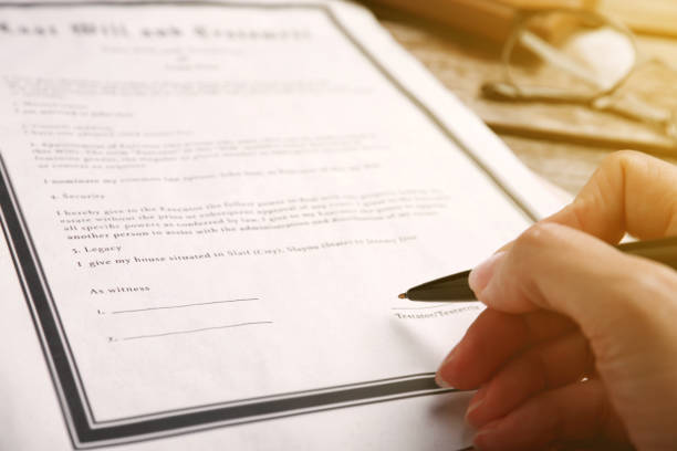 istock Woman signing Last Will and Testament at table, closeup 1878160751