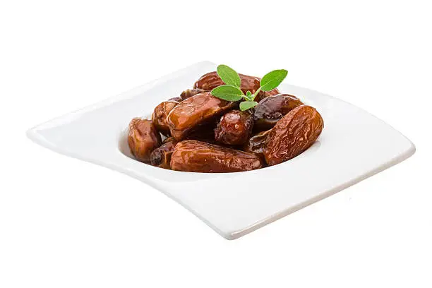 Dates with leaf on the plate