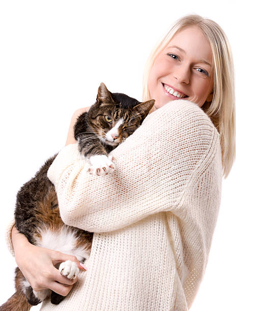 istock Young Blond Woman Smiles Holding Kitten isolated 187817456