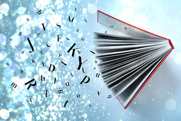 istock Open book with many letters on light blue background, top view. Bokeh effect 1878179072