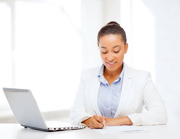 istock african businesswoman writing something 187820172