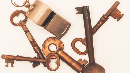 Old broken key isolated on a white background