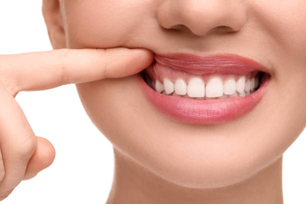 istock Woman showing her clean teeth on white background, closeup 1878216528