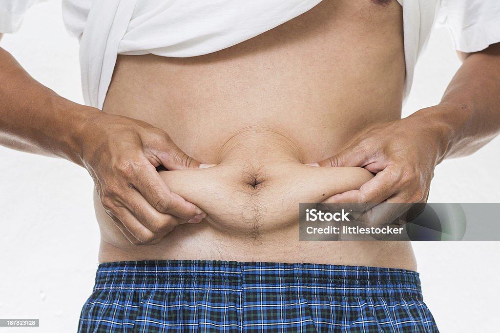 Homme montrant son gros sur le ventre - Photo de Abdomen libre de droits