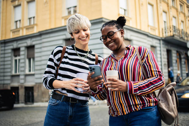 istock Two happy young women are having fun outside 1878346685