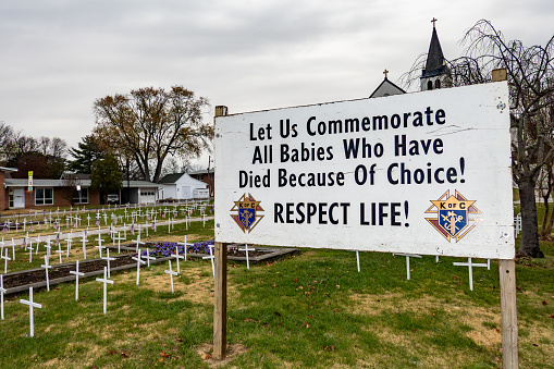 Solomons, Maryland, USA Dec 1, 2023 An anti-abortion sign and fake crosses in a church yard of the