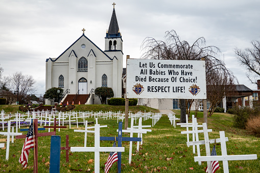 Solomons, Maryland, USA Dec 1, 2023 An anti-abortion sign and fake crosses in a church yard of the