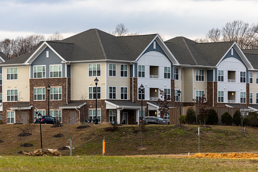 Exterior view in a suburban neighborhood in North Carolina. Three, multi-story town homes