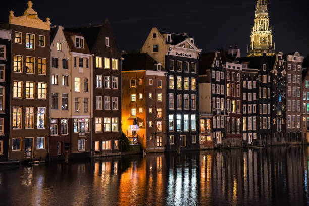 istock Amsterdam Old houses at night 1878359330
