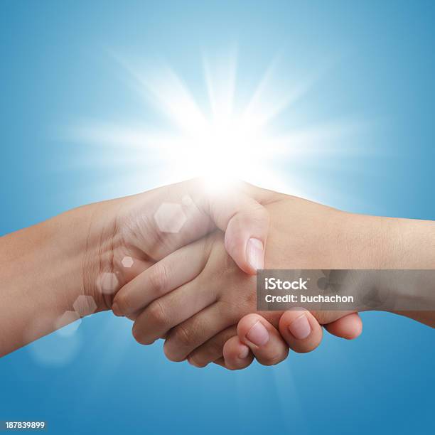 Handshake On Blue Sky And Sunlight Stock Photo - Download Image Now - Adult, Agreement, Blue