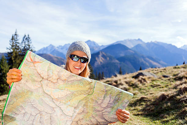 istock Woman hiker reading map in mountains 187839950