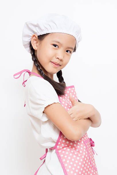 istock Little Asian cute chef wearing pink apron 187840948