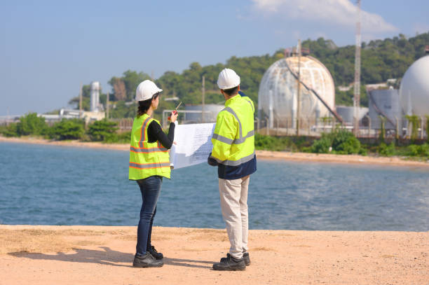 istock Two chemical engineers consult to prepare a work plan for a refinery storage tank. 1878422589