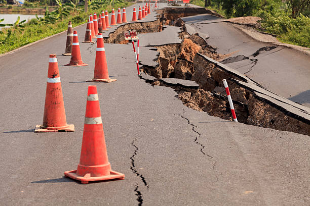 istock Traffic cones on the cracked asphalt road 187845226
