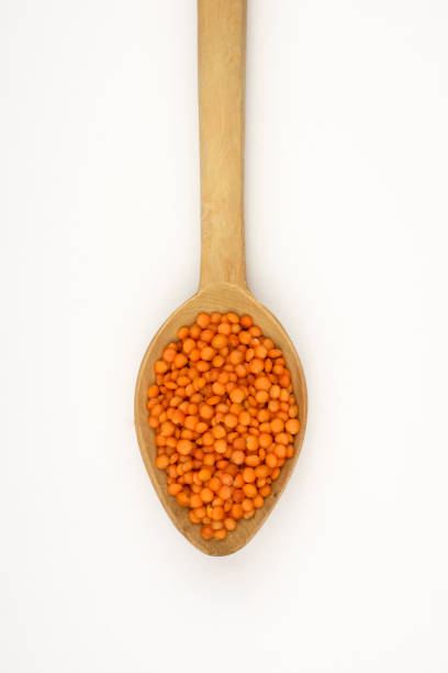 red lentils with wooden spoon, isolated on a White Backgorund