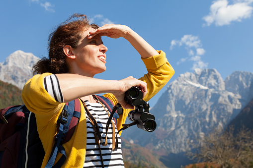 Serene Brunette Mid Adult Woman Tourist Enjoying Journey in Mountains And Looking Ahead for Adventure