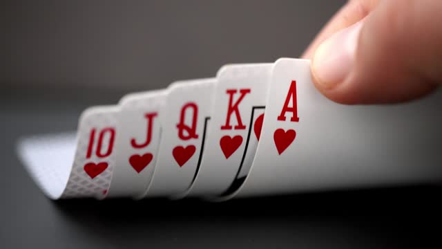 A person looking at a Royal flush An ace-high straight flush, the best possible hand in many variants of poker.