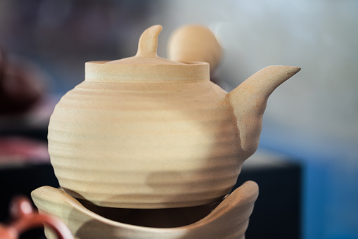 Beautiful clay jar, isolated on a white background.