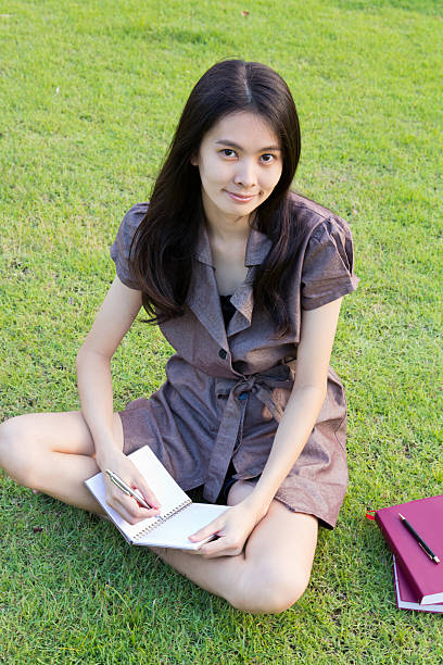 istock Cute young woman writing the book 187851389