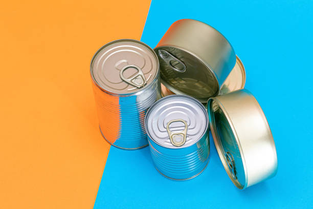 istock A Group of Stacked Tin Cans with Blank Edges on Split Blue and Orange Background 1878516432
