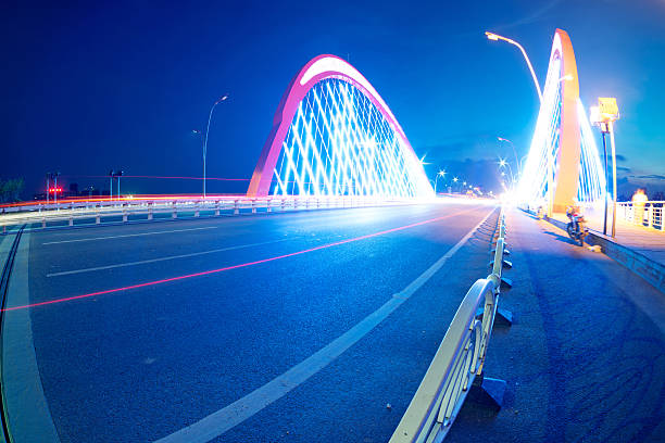 istock cars light trails on the modern bridge at dusk 187852159