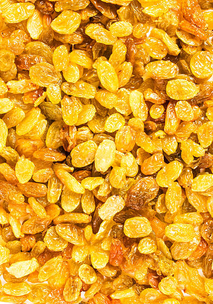 Yellow Raisins may use as textured background, close up.