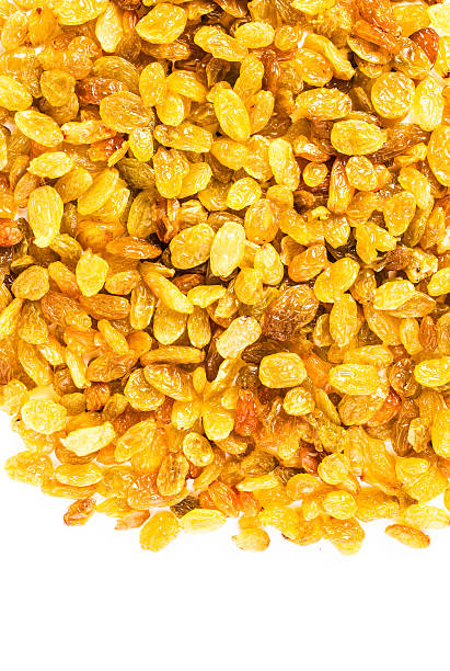 Golden Shiny Raisins isolated on white background. Yellow great