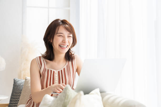 young asian woman using laptop stock photo