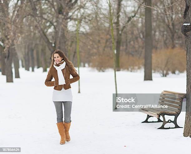 Happy Young Woman Walking In Winter Park Stock Photo - Download Image Now - Adult, Adults Only, Alley