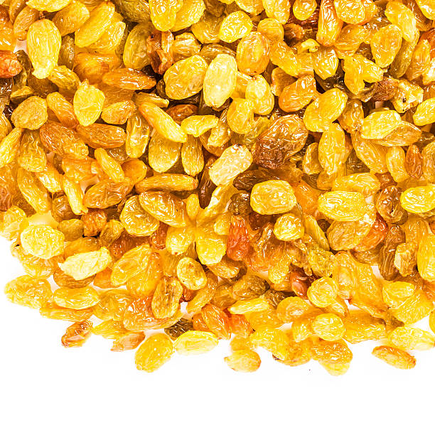 Yellow Golden Shiny Raisins isolated on white background, nacro.