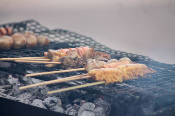 grilling bbq skewers at a food stall