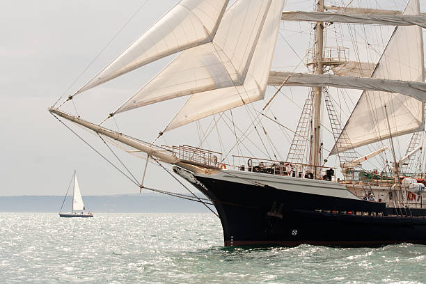 istock Old ship with white sales, sailing in the sea 187860623