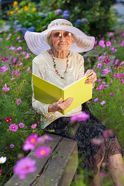 istock Elegant elderly lady reading in the garden. 187861218