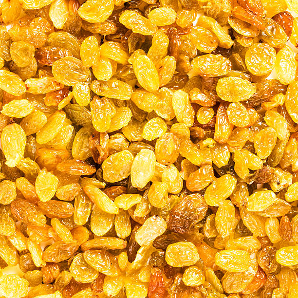 Yellow Golden Shiny Raisins may use as textured background, clos