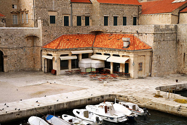 Backyard with cozy restaurants in Croatia, Dubrovnik after season. Famous old town fortress on the Adriatic.
