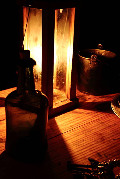 istock Candlelight Lantern on Wooden Table with Bottle 187863094